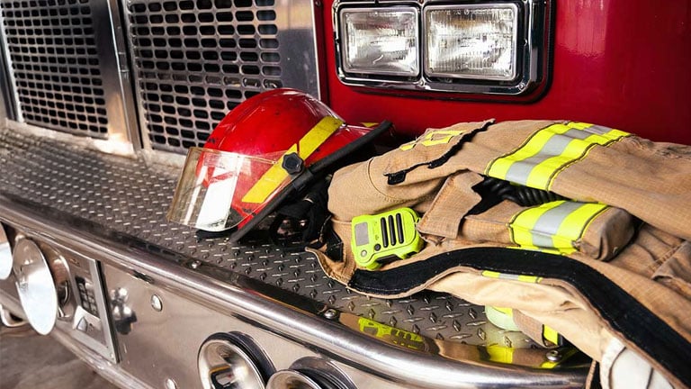 Firefighter gear on the front of a firetruck