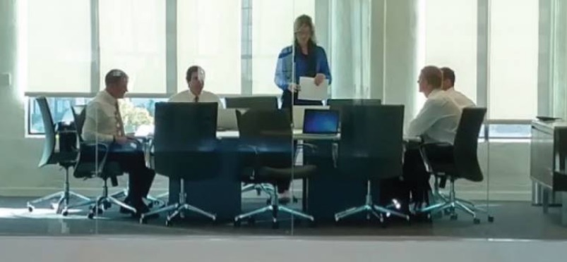 A group of people having a meeting around a conference table