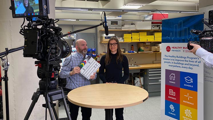 A student and camera crew shooting a video