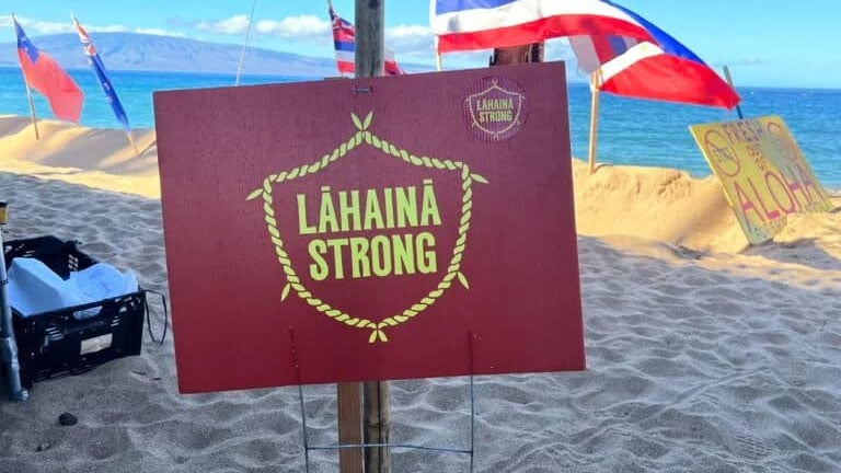 A sign on the beach displaying the words: Lahaina Strong